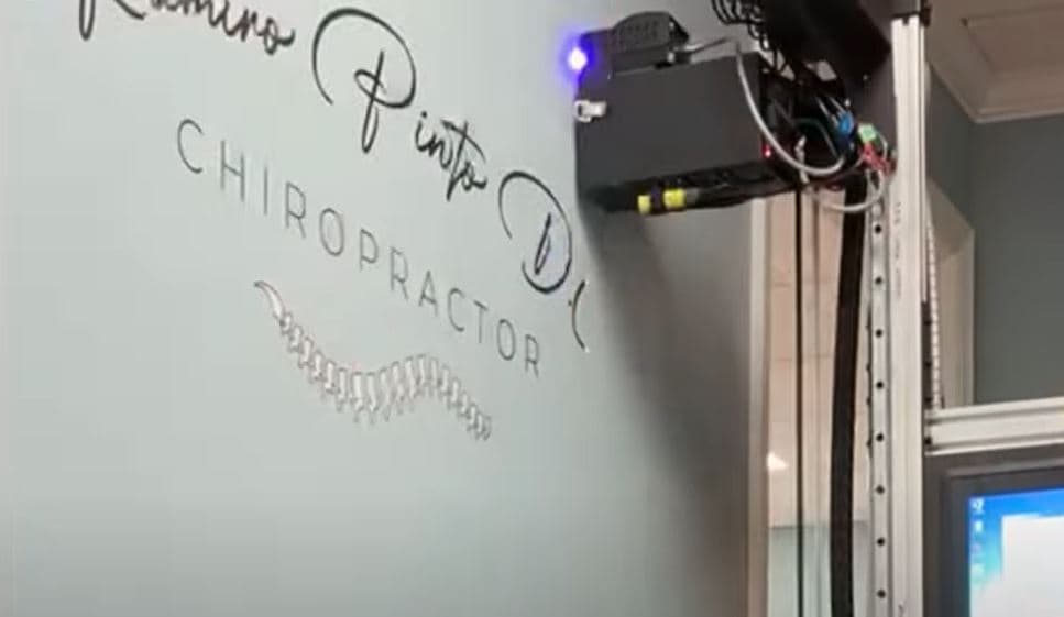 Chiropractor logo printed directly onto an office wall with a vertical printer