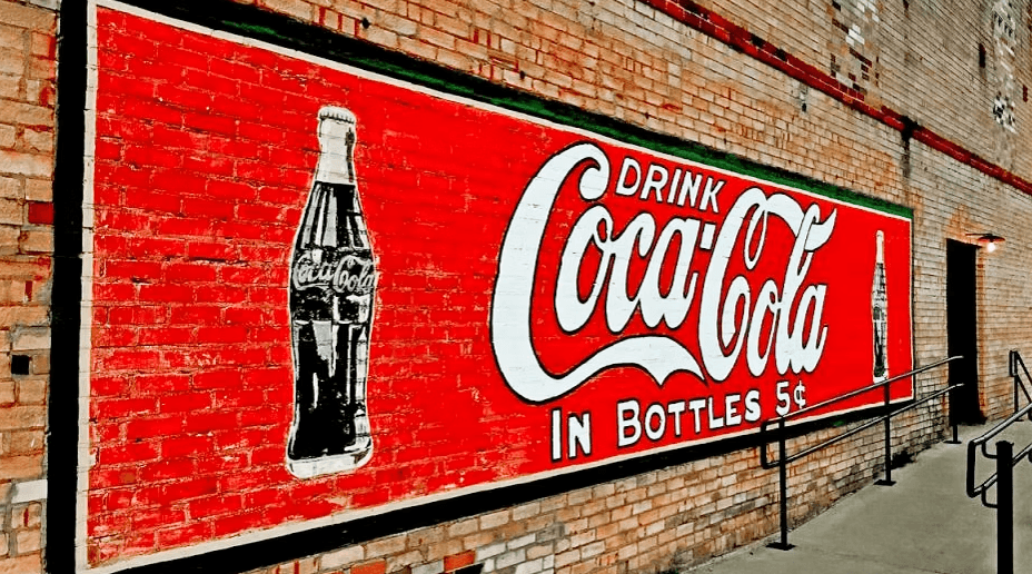 Vintage-style sign printed on an exterior brick wall