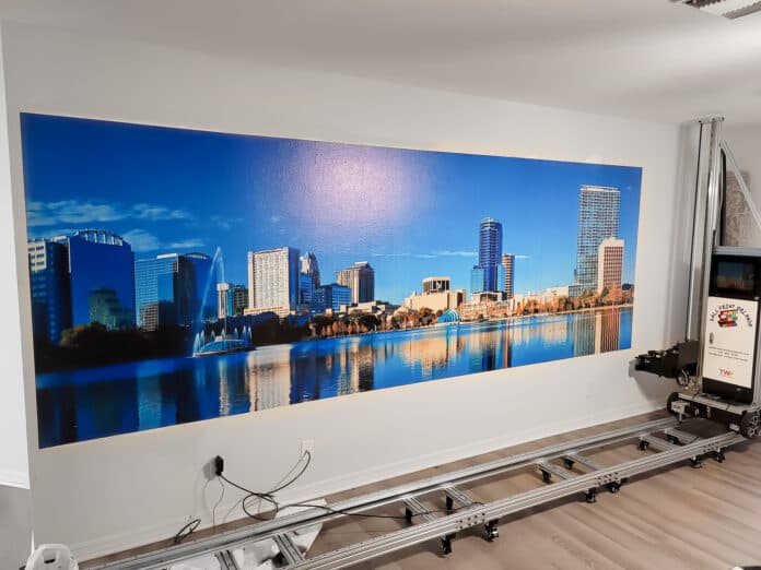 Large city skyline mural printed directly onto an office wall with a vertical wall printer